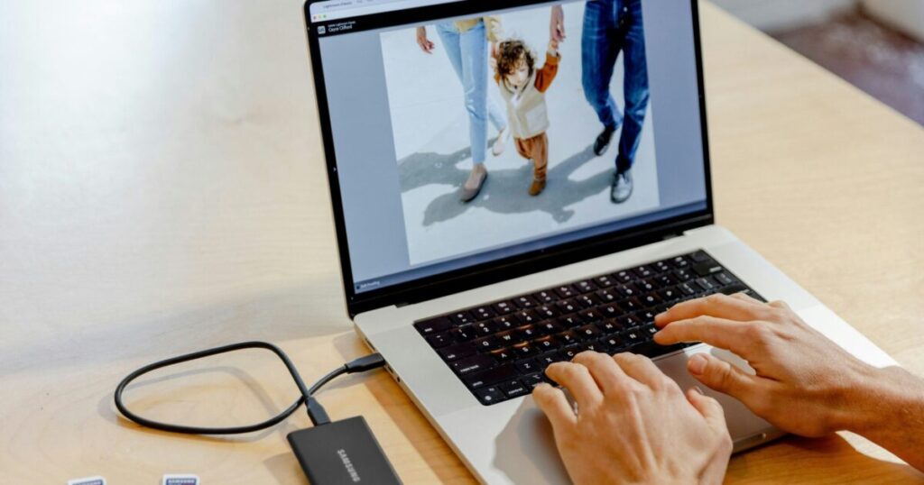 Camera and laptop on a professional photography workspace